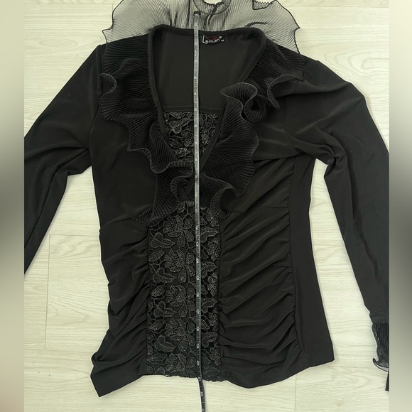 black long-sleeved women's blouse featuring a ruffled neckline and floral lace - Picture 4 of 6